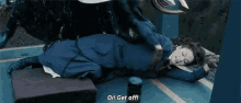 a woman in a blue dress is laying on the floor and says get off