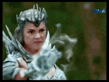 a woman in a costume with the word gma on the bottom left