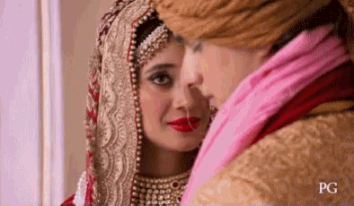 a bride and groom are looking at each other with pg written on the bottom right