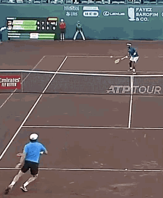 a tennis match is being played on a court with emirates airlines advertisements on the wall