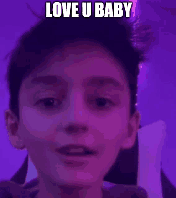 a young boy is making a funny face in front of a purple background with the words `` love u baby '' .