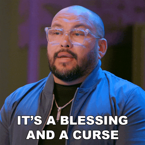 a bald man wearing glasses and a blue jacket says it 's a blessing and a curse