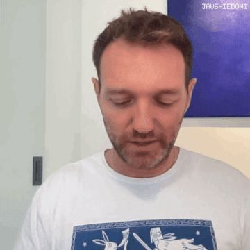 a man wearing a white t-shirt with a picture of a rabbit and the word jawshiedomi on the bottom