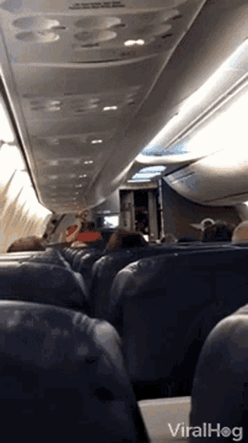 a video of people sitting on an airplane with the words viralhog on the bottom