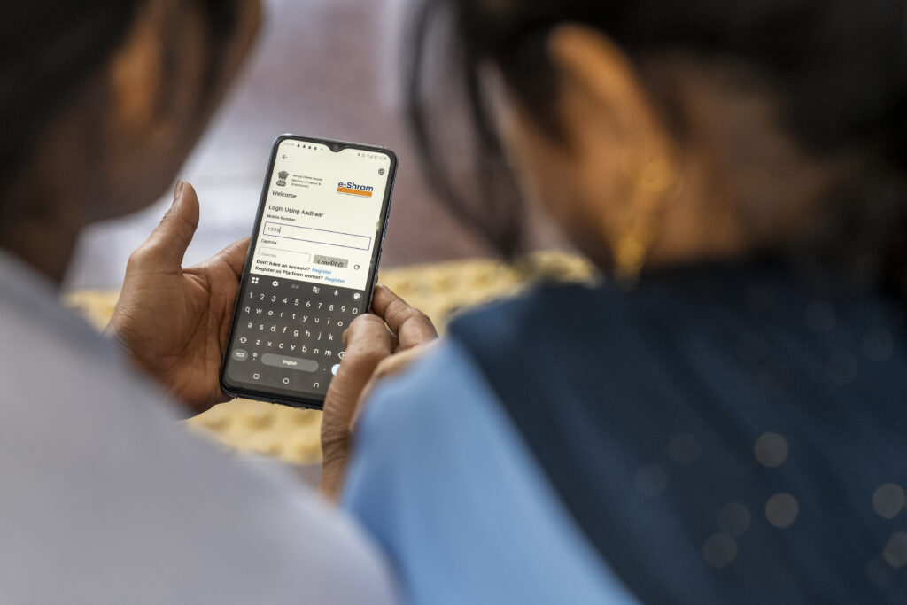 Two people looking at a phone screen.
