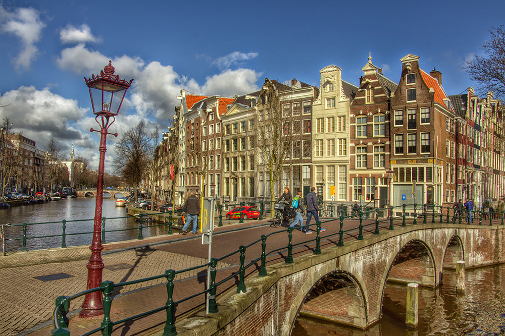 People walking on pedestrian bridge across channel in beautiful old city, netherlands, amsterdam, keizersgracht image in Architecture and Buildings category at pixy.org