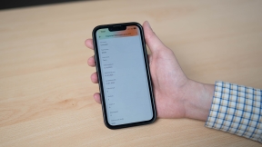 The photo shows a hand holding a smartphone which displays a digital baccalaureate certificate.