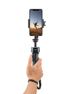 A hand using the closed JOBY tripod as a handgrip to easily point the mounted iPhone in any direction.