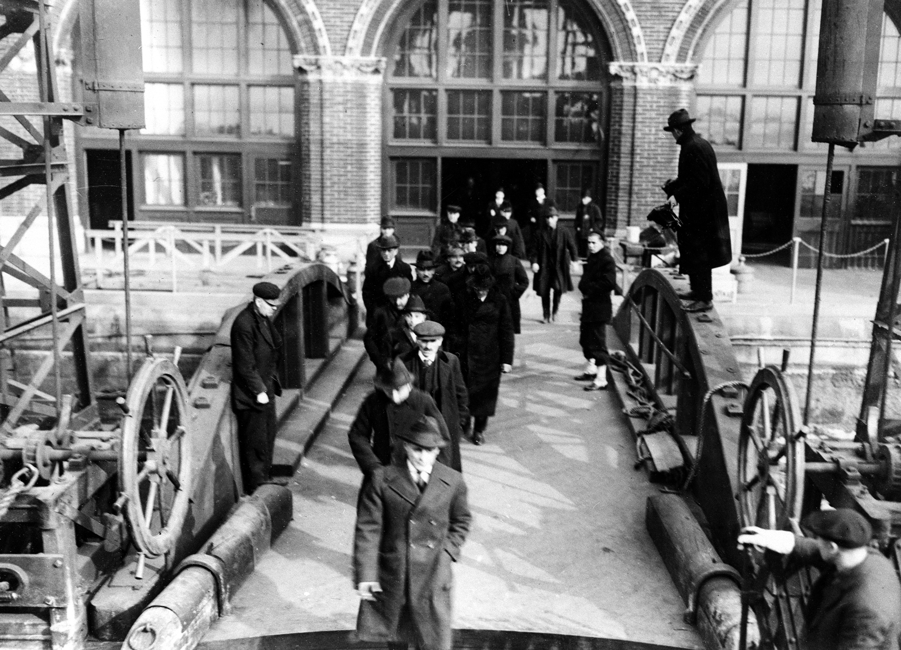 People who have been arrested in the federal drive against radicals are shown as they arrive at Ellis Island, in New York City, on April 7, 1920. Deportation hearings are held on the island to determine whether they are to stay in the United States. (AP Photo)