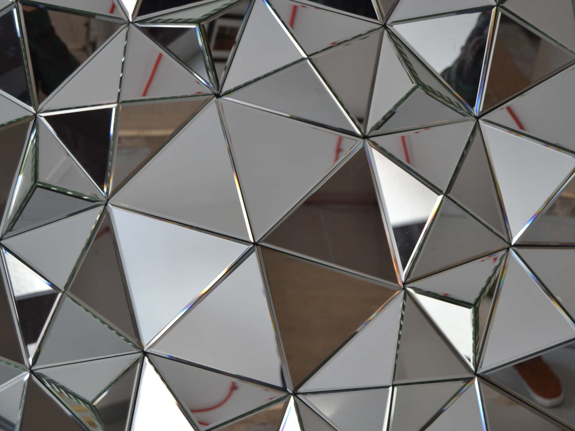 Image  A glimmering mirror against a foliage backdrop