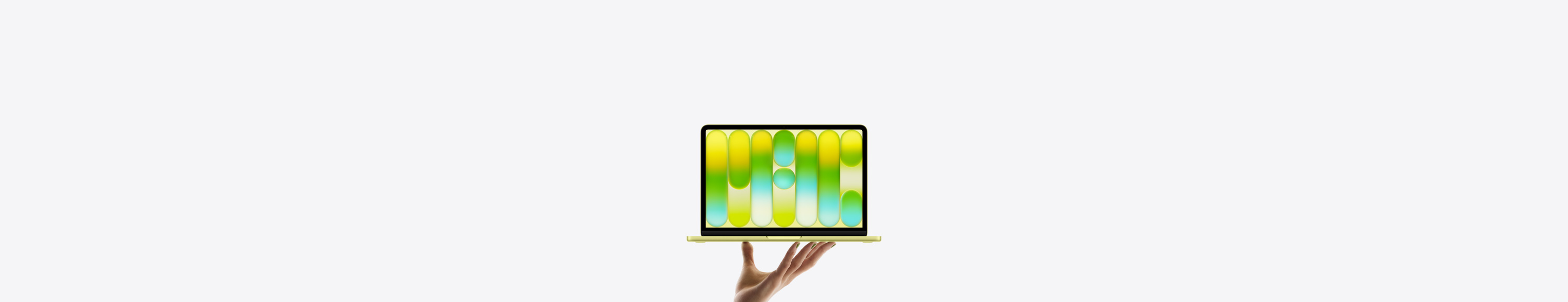 MacBook Neo dans une couleur pastel jaune agrume, en équilibre sur le bout des doigts d’une main ouverte, l’écran affichant un motif abstrait coloré