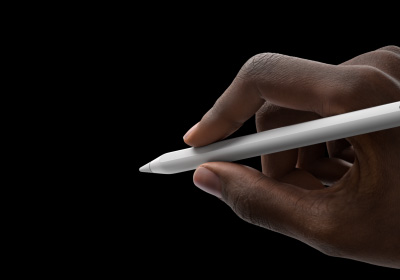 使用者的一隻手握著 Apple Pencil Pro，呈書寫姿勢。筆尖指向展示新工具面板的介面。