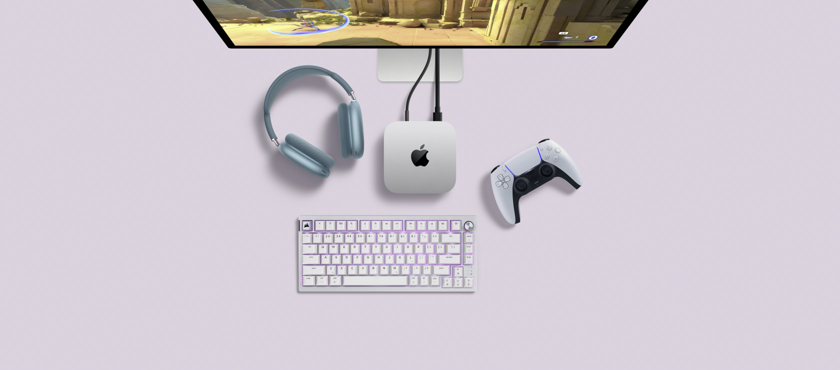 A desk setup showing Mac mini plugged into a display and next to a wireless keyboard and mouse.