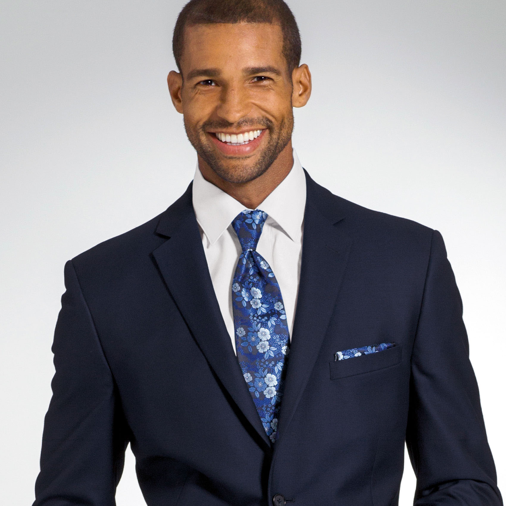 Man in navy blue suit rental with floral tie
