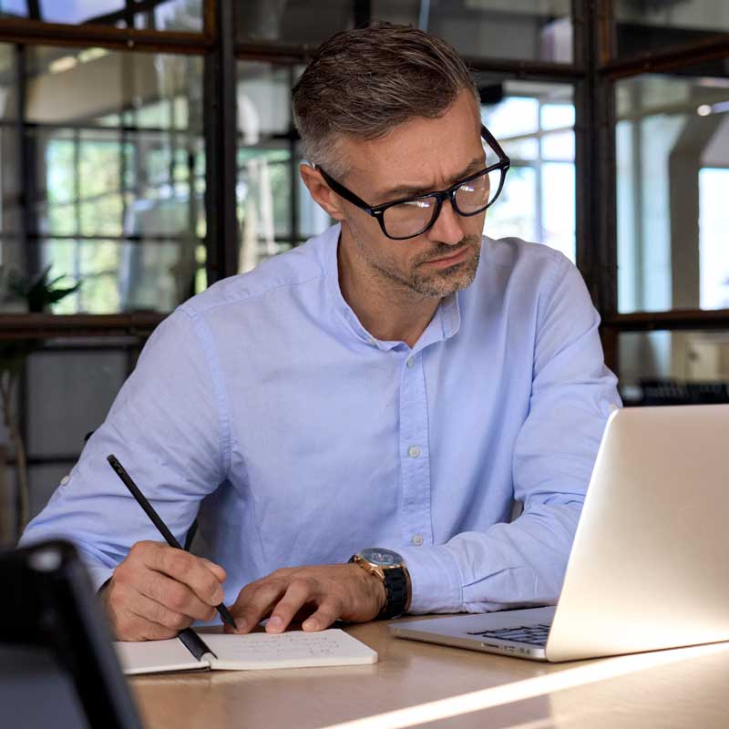 Mature,Business,Man,Executive,Manager,Looking,At,Laptop,Computer,Watching