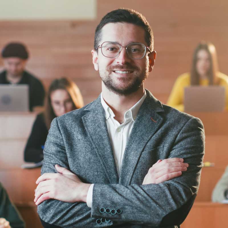 Portrait,Shot,Of,Man,Professor,At,Class.,Students,On,Background.