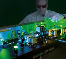Lab technician working with high-precision laser equipment, symbolizing Ekspla’s cutting-edge technology in laser systems, supported by a strong patent portfolio to secure innovation and market leadership.