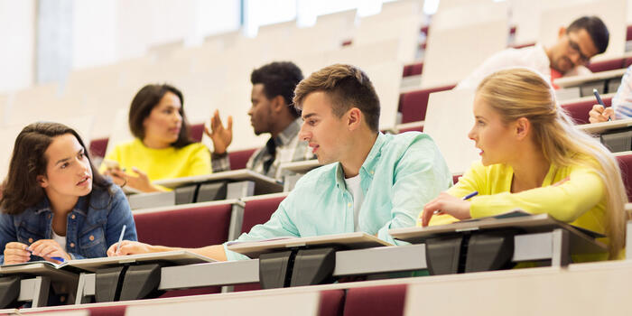 Students sitting in university room and talking