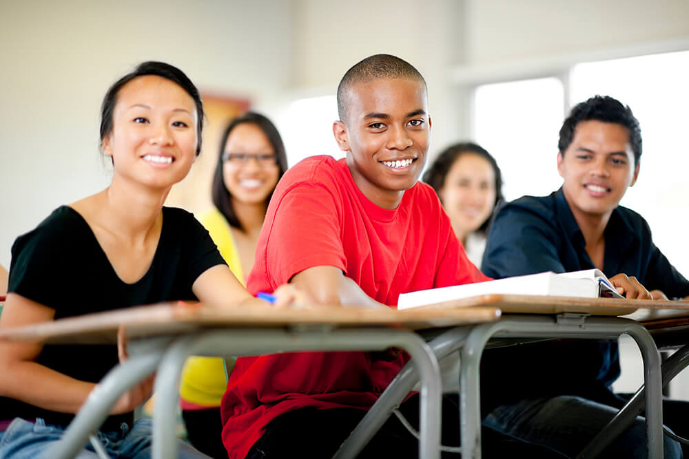 high school students sitting at desks in classroom