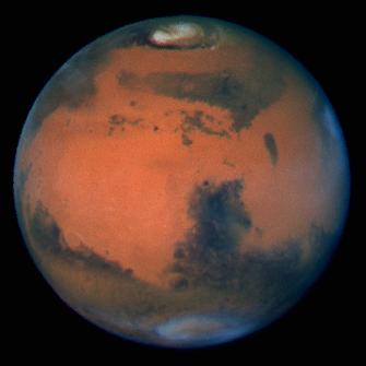 Mars stands out against the blackness of space. The planet appears as a bright orange orb swirling with blue and white shadows.