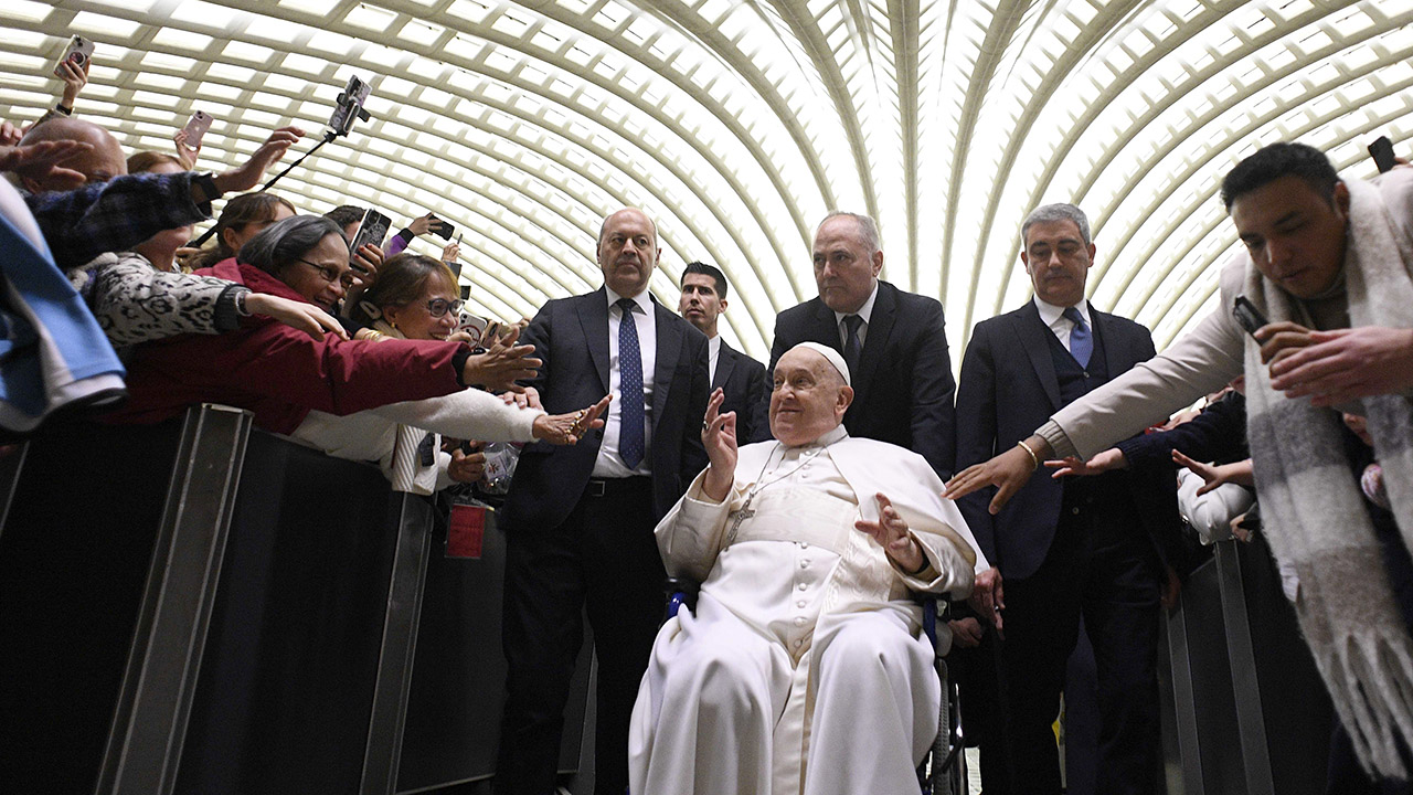 Pope Francis greets attendees of his weekly General Audience at the Paul VI Hall in Vatican City on Feb. 12, 2025, days before he was hospitalized. (Vatican Media via Vatican Pool/Getty Images)