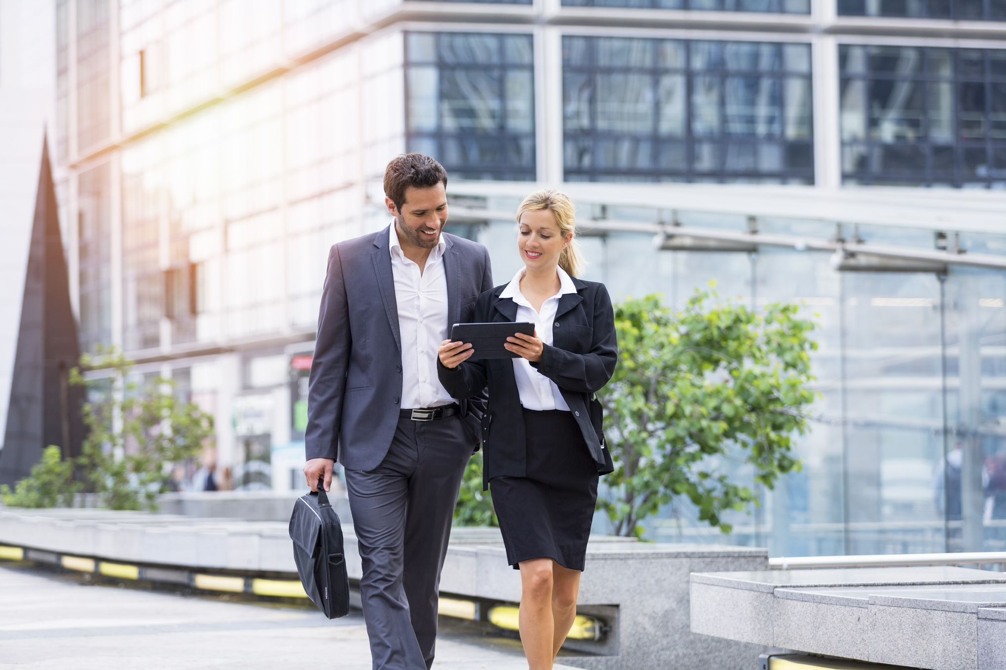 two people in suits walking 