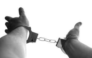 a person in handcuffs because they engaged in sex with a minor they thought was an adult